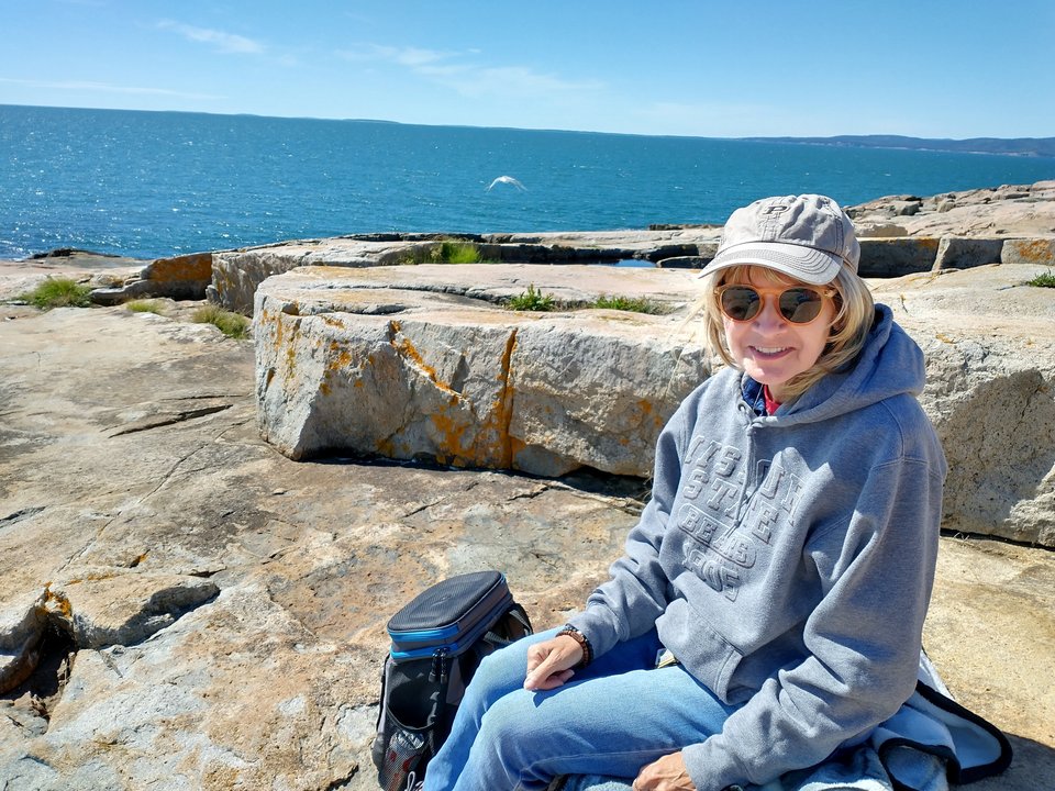 Michelle on rocks with ocean in background